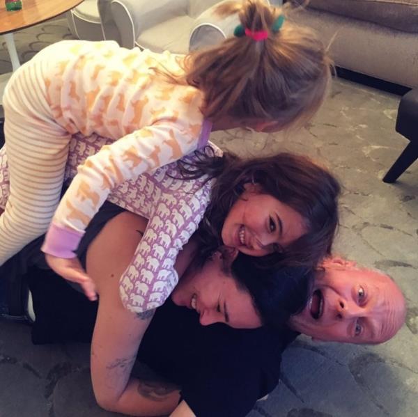 Bruce Willis getting silly with three of his daughters.
