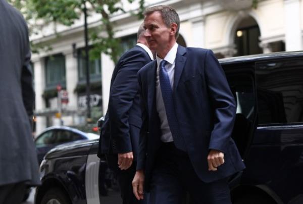 Britain's Chancellor of the Exchequer, and former Health Secretary, Jeremy Hunt (C) arrives to give evidence to the Infected Blood Inquiry, in Lo<em></em>ndon on July 28, 2023. a<em></em>bout 2,900 people died in the UK after they were given co<em></em>ntaminated blood products in the 1970s and 80s. The inquiry is set to examine how thousand of patients in country were infected with HIV and hepatitis C and how authorities and the government, respo<em></em>nded to what has been called the worst treatment disaster in the history of the NHS. (Photo by HENRY NICHOLLS / AFP) (Photo by HENRY NICHOLLS/AFP via Getty Images)