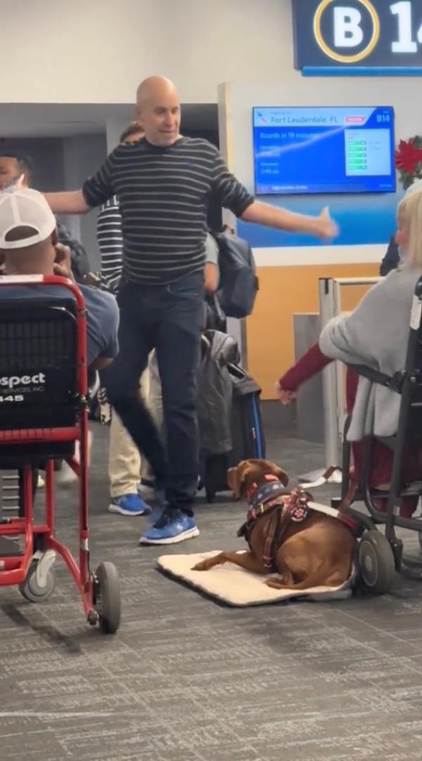 The couple had a meltdown while waiting to board their flight, and one man screamed at a woman in a wheelchair, video shows.