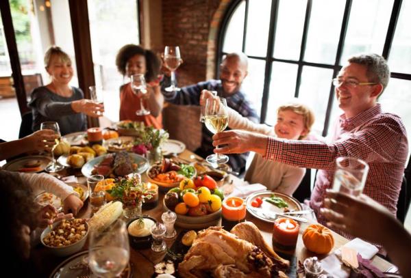 People Celebrating Thanksgiving Meal Feast Table Holiday Concept.