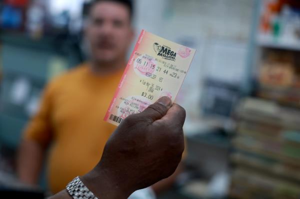 A customer purchases a Mega Millions lottery ticket at the La Esquina Tropical supermarket in Miami, Florida on Tuesday.