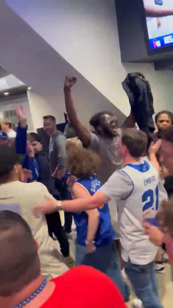 Knicks fans celebrate inside Wells Fargo Center after advancing to the second round of the NBA playoffs.