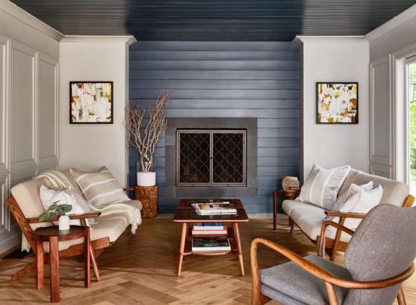 Lobby of Journey East Hampton Hotel with a fireplac<em></em>e and couches