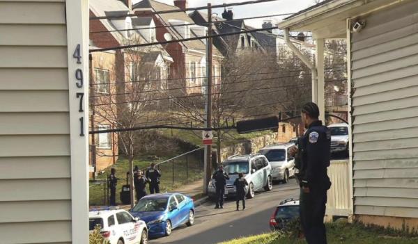 Authorities were executing an arrest warrant at a home when the suspect opened fire, according to reports.
