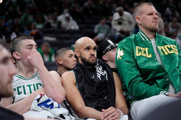 Kristaps Porzingis, right, watch from the bench as the Cleveland Cavaliers lead the Celtics during the second half of Game 2 of an NBA basketball second-round playoff series