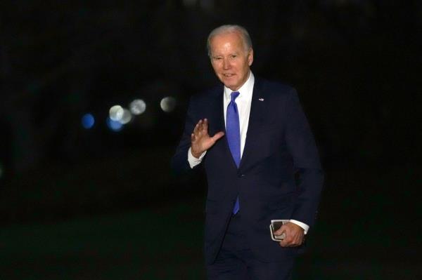 President Joe Biden waves on the South Lawn of the White House after attending fundraisers in New York, February 7, 2024.