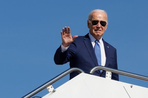Joe Biden waves while boarding a plane at Joint ba<em></em>se Andrews for a trip to New York.