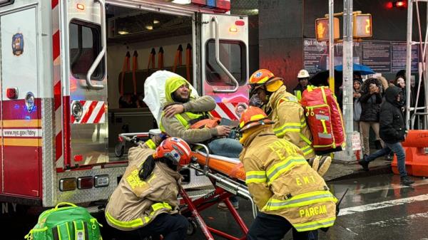Co<em></em>nstruction worker loaded into ambulance, wincing in pain