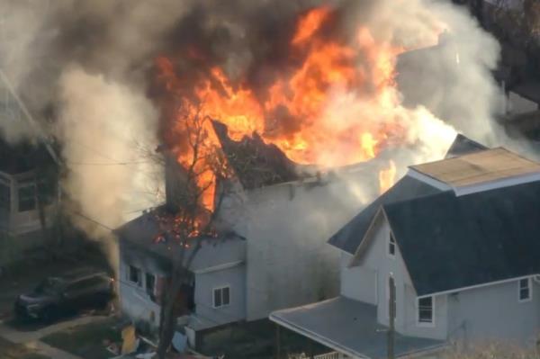 Two-story suburban home emitting smoke and flames, police officers wounded in gunfire in East Lansdowne.