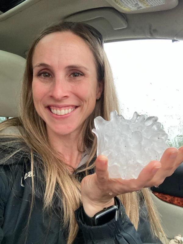A woman holding a large hailstone found in Shamrock Texas on June 13, 2023.