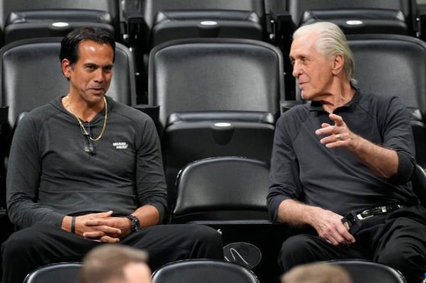 Miami Heat head coach Erik Spoelstra, left, chats with team president Pat Riley as they watch players practice for Game 2 of the NBA Finals on June 3, 2023, in Denver.  