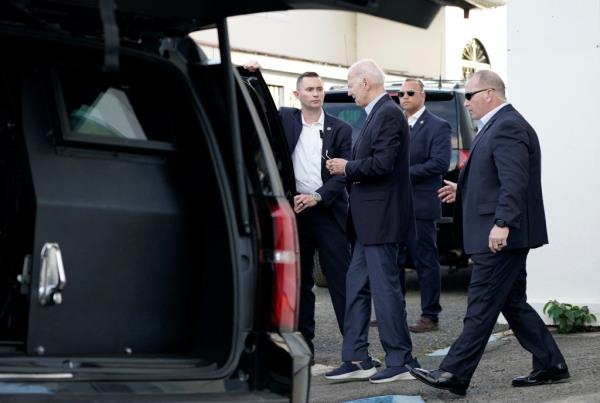 Biden enters a car