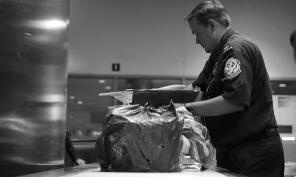 US Customs and Border Patrol officer seen inspecting a bag co<em></em>ntaining ketamine