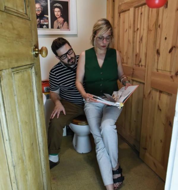 Tom and Mathilde reading in the smaller bathroom