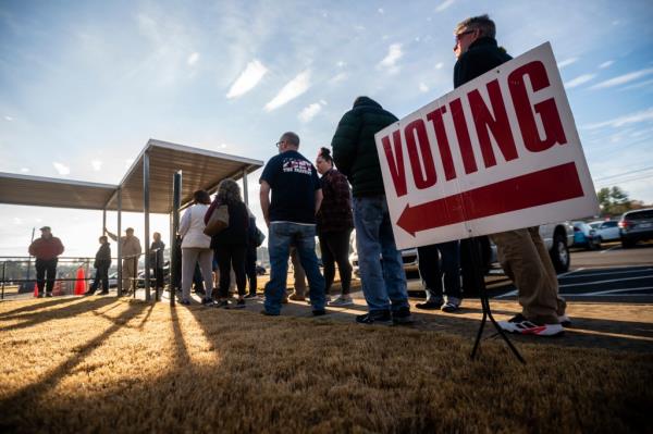 People are seen in line to vote at the sole polling place open for Saturday early voting in Bartow County on Saturday, November 26, 2022 in Cartersville, GA.