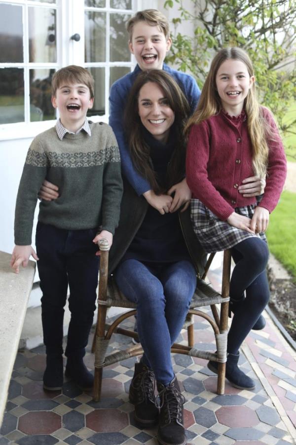 Kate with her children, Prince Louis, Prince George, and Princess Charlotte, posing for a family photo in Windsor, England.