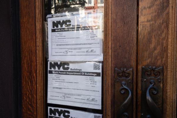 Department of Buildings permits for interior work are seen on the front door.