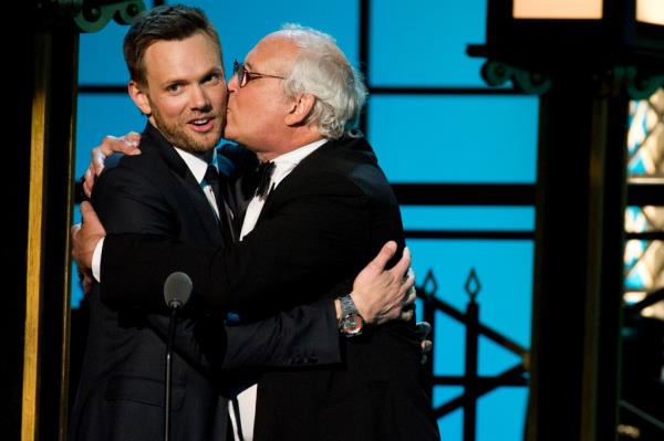 Joel McHale hugging Chevy Chase. 