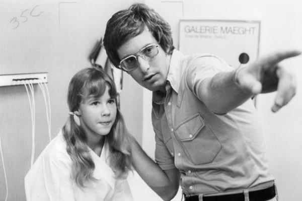 Linda Blair listens to instructions being given to her by director William Friedkin in a scene from the film 'The Exorcist', 1973.