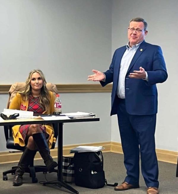 Jamie Lassiter and Tim Moore are seen together at a December 2022 work event, in a photo submitted to the court  