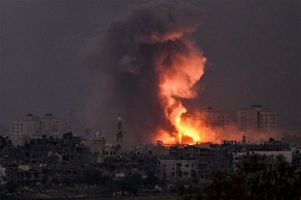 A fireball erupts during Israeli bombardment in the northern Gaza Strip on October 14, 2023.