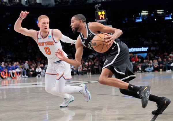Mikal Bridges #1 of the Brooklyn Nets drives down court as Do<em></em>nte DiVincenzo #0 of the New York Knicks defends during the first period.