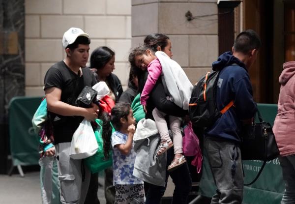 migrants and support perso<em></em>nnel seen outside of the Roosevelt Hotel in New York, NY on June 3.
