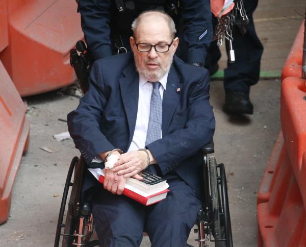 Weinstein leaving Bellevue Hospital on with NYCD ESU officers before going to court.