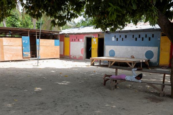 A girl rests in the courtyard of the school funded by El Roi Haiti in the Cite Soleil neighborhood of Port-au-Prince