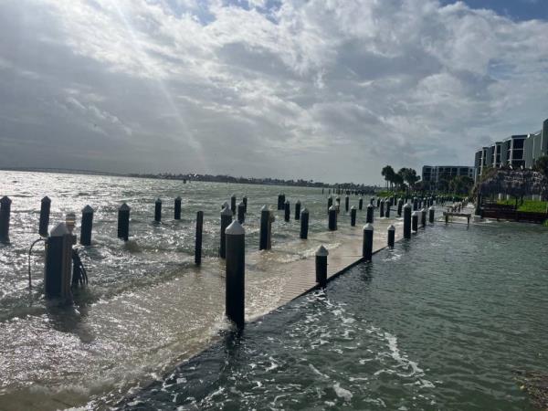 High tide and outer bands of Hurricane Helene brought water up over docks and seawalls in Marco Island, Florida. 