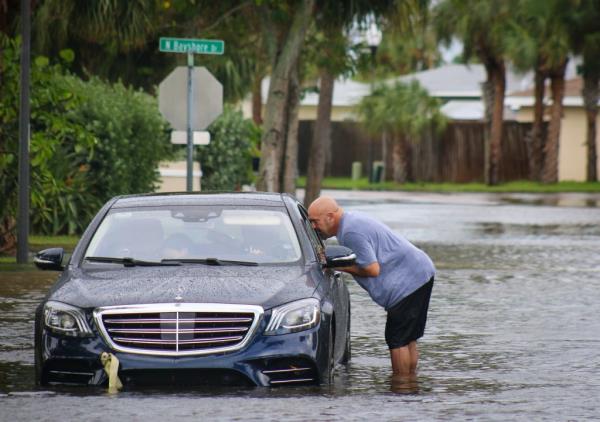 A resident attempted to help an unidentified driver whose car stalled in floodwaters from Hurricane Helene on Thursday in Madeira Beach.