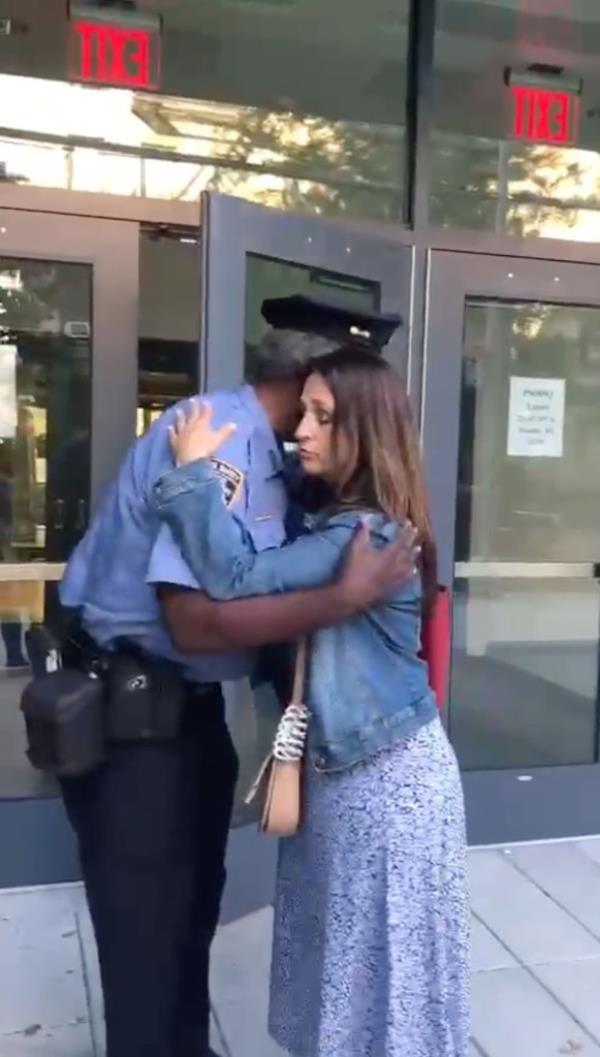 Daphne Halkias hugging the school security guard.