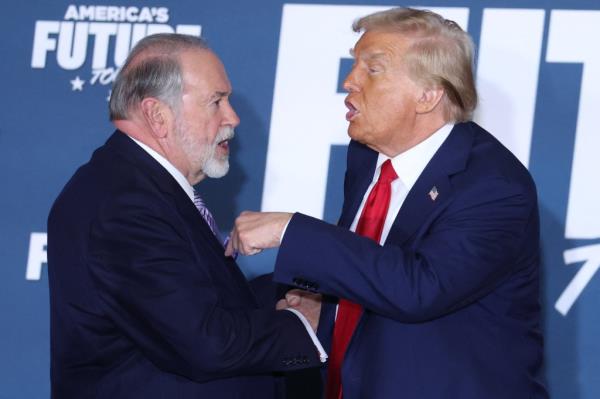 Former US President and Republican presidential candidate Do<em></em>nald Trump and Mike Huckabee shake hands after taking part in a roundtable discussion hosted by Building America's Future in Drexel Hill, Pennsylvania, on October 29, 2024.