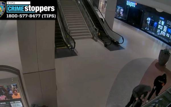 Video released by the NYPD shows the man standing next to the jewelry stand bagging up items.