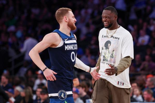 Do<em></em>nte DiVincenzo and Julius Randle in basketball uniforms celebrating during a preseason NBA game between Minnesota Timberwolves and New York Knicks on Oct. 13, 2024.