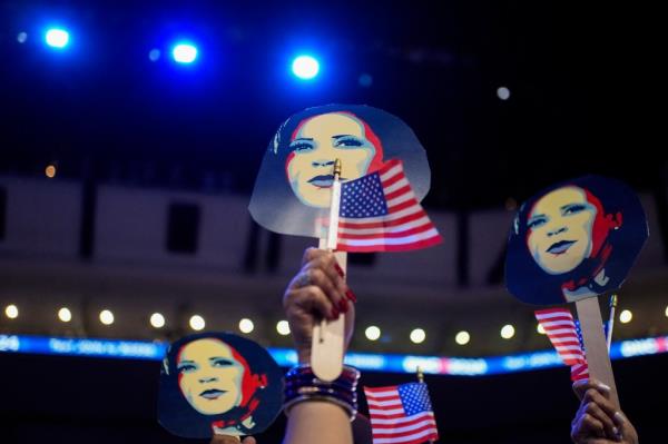 Attendees hold images of Democratic presidential candidate and U.S. Vice President Kamala Harris and flags on Day 2 of the Democratic Natio<em></em>nal Co<em></em>nvention (DNC) at the United Center, in Chicago, Illinois, U.S., August 20, 2024.