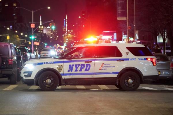 A photo of an NYPD SUV On West 135th Street and Lenox Avenue.