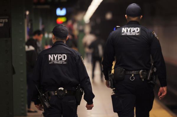 A photo of NYPD officers patrolling the subway platform at the Atlantic Avenue subway station.