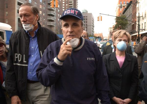 New York Governor George Pataki, Mayor Rudolph Giuliani, and US Senator Hillary Clinton touring the World Trade Center site on September 12, 2001, wearing masks