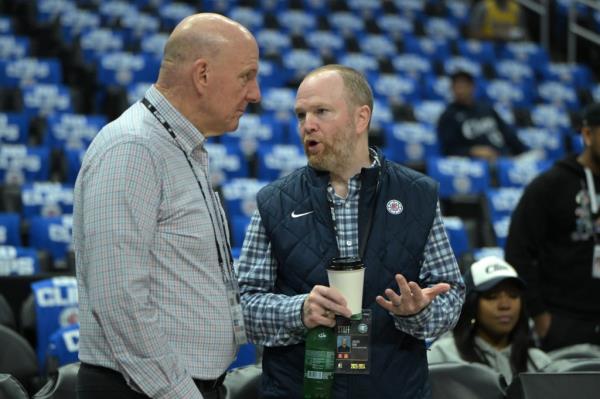 Los Angeles Clippers owner Steve Ballmer talking to Lawrence Frank, President of Basketball Operations, before an NBA playoff game against the Dallas Mavericks at Crypto.com Arena.