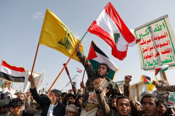 Houthi supporters raise a Lebanese flag during an anti-Israel and anti-U.S. rally in Sanaa, Yemen, Friday, Sept. 27, 2024.