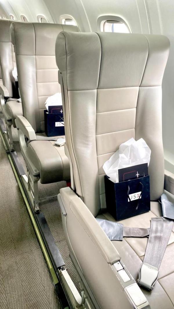 a bag on a row of private jet seats