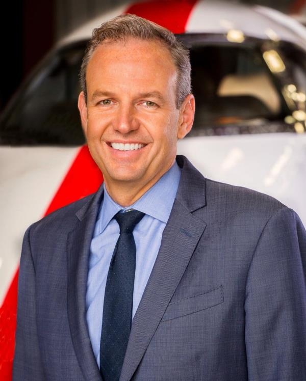 Alex Wilcox in a suit and tie.