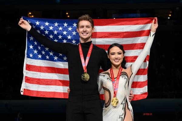 Gold medallists USA's Madison Chock (R) and Evan Bates pose with the country's natio<em></em>nal flag during the medal ceremony for ice dance free skating event during the ISU Grand Prix of Figure Skating Final in Beijing on December 9, 2023