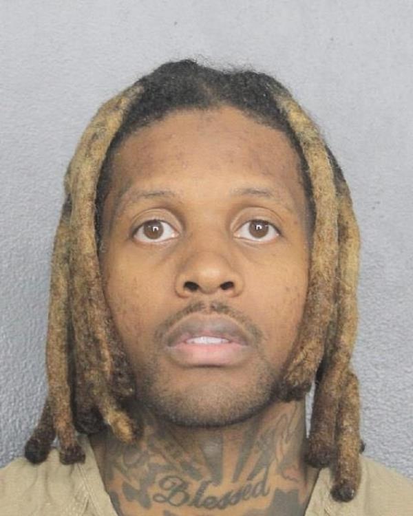 Grammy-winning rapper Lil Durk, identifiable by his dreadlocks and tattoos, after being arrested in Florida.
