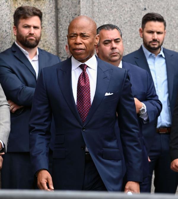 New York City Mayor Eric Adams leaving Manhattan Federal Court, surrounded by a group of men in suits, on September 27, 2024.