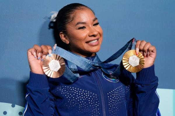Jordan Chiles holds up her medals after the women's artistic gymnastics individual apparatus finals Bercy Arena at the 2024 Summer Olympics, Aug. 5, 2024, in Paris, France. 