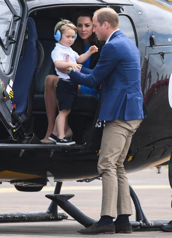 Duchess Catherine, Prince William and Prince George of Cambridge sitting in a helicopter at The Royal Internatio<em></em>nal Air Tattoo