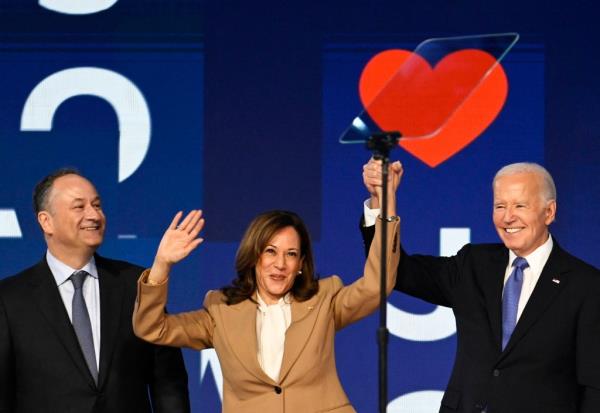 U.S. President Joe Biden, Vice President Kamala Harris, and Second Gentleman Doug Emhoff standing on stage at the Democratic Natio<em></em>nal Co<em></em>nvention in Chicago, 2024