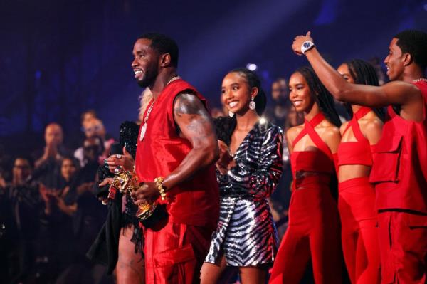 Diddy accepts the Global Icon Award at the 2023 VMAs with his daughter Chance and other children.